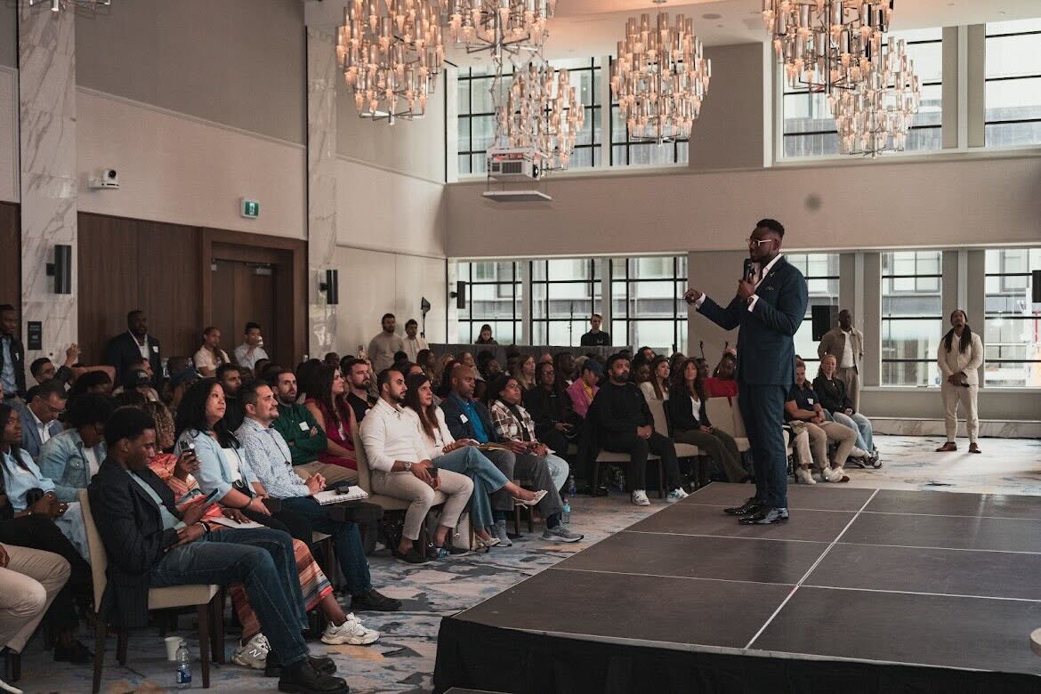 Mo' Ekujumi speaking to a packed room of professionals