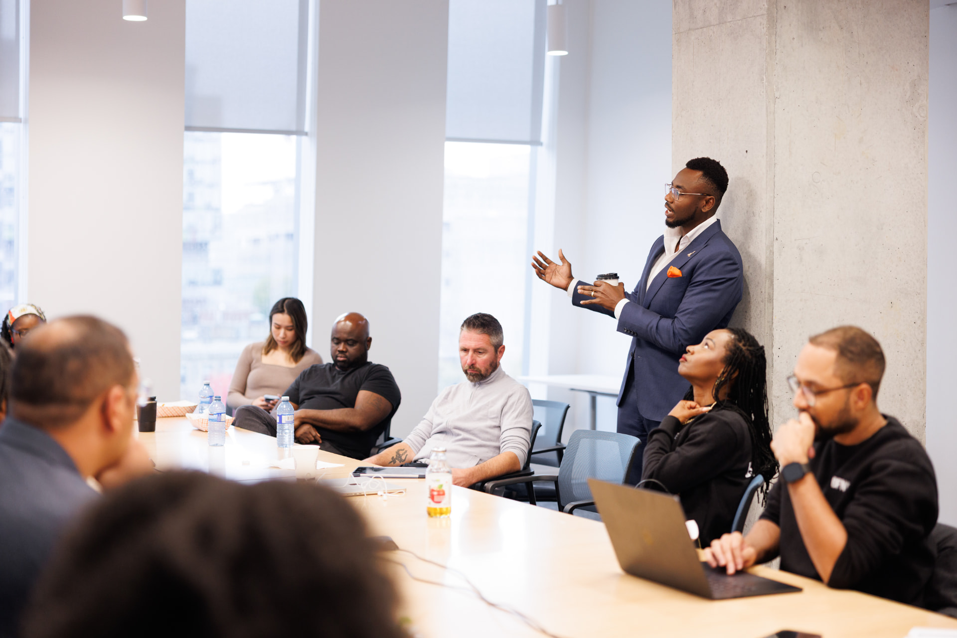 Mo' Ekujumi leading a boardroom session with participants